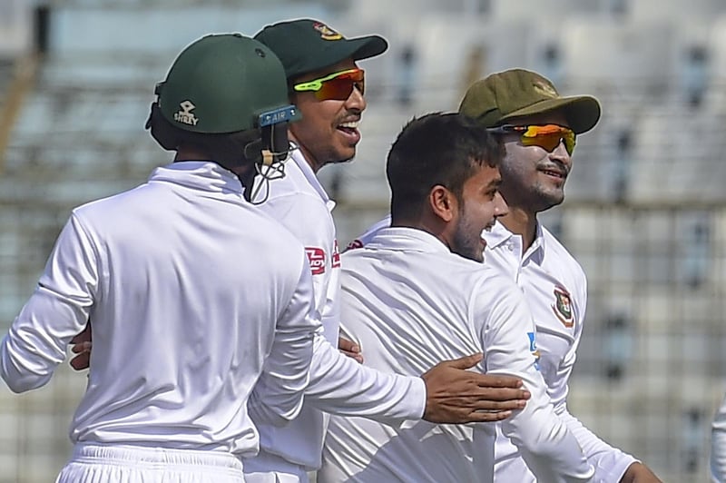 Bangladeshi cricketer Mehidy Hasan (2R) celebrates with captain Shakib Al Hasan (R) after the dismissal of West Indies cricketer Shimron Hetmyer during the third day of the first Test cricket match between Bangladesh and West Indies at the Zahur Ahmed Chowdhury Stadium in Chittagong on November 24, 2018. / AFP / MUNIR UZ ZAMAN
