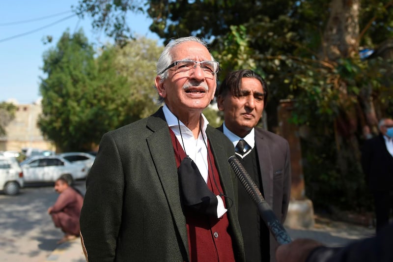 Mahmood Sheikh (L), lawyer of British-born militant Ahmed Omar Saeed Sheikh, speaks to media representatives after the high court ordered to release Omar Saeed Sheikh on the murder case of American journalist Daniel Pearl, outside the Sindh high court in Karachi on December 24, 2020.  A court in Pakistan on December 24 ordered the release of a British-born militant convicted of murdering American journalist Daniel Pearl who was kidnapped and beheaded in the southern city of Karachi in 2002.  / AFP / Rizwan TABASSUM
