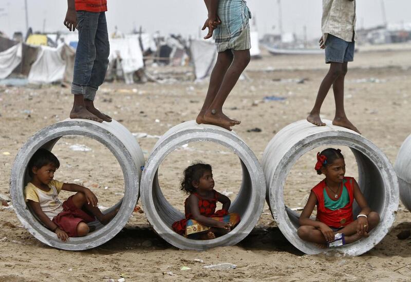 Children sitting inside cement water pipes play on the Marina beach in the southern Indian city of Chennai. Babu / Reuters