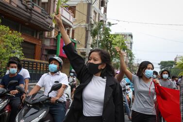 A demonstrator gives a three-finger salute during an anti-military coup protest in Mandalay, Myanmar. EPA