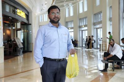 DUBAI , UNITED ARAB EMIRATES , April 4 – 2019 :- Jithin Alex holding plastic bag after doing shopping at the Spinneys  supermarket in Dubai Marina in Dubai. ( Pawan Singh / The National ) For News. Story by Patrick