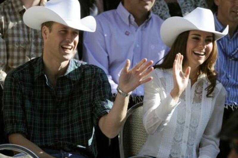 Prince William and Catherine, the Duchess of Cambridge wave at the start of the 2011 Calgary Stampede Parade in Calgary, Alberta on their nine-day tour in Canada July 8, 2011.  AFP PHOTO / TIMOTHY A. CLARY