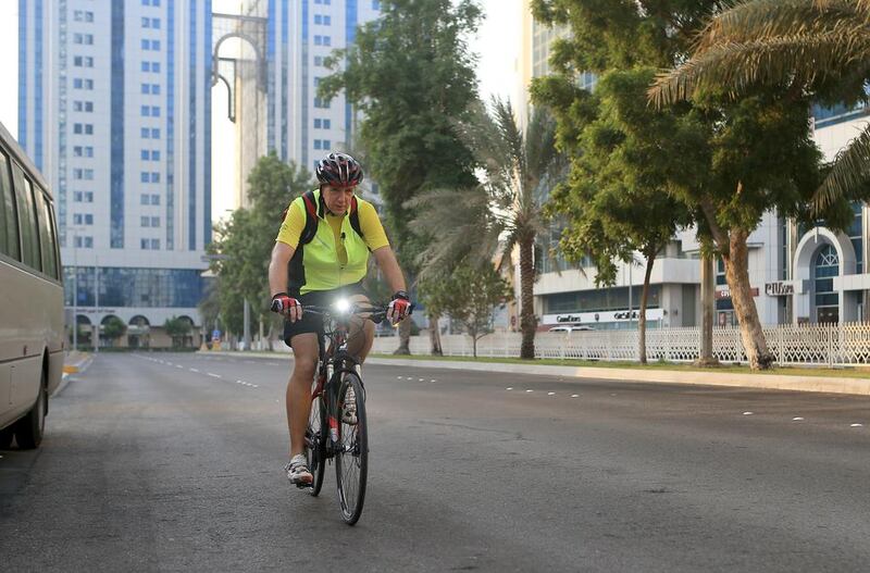 Cyclist Peter Mueller commuting to work daily to the Corniche in Abu Dhabi. Ravindranath K / The National