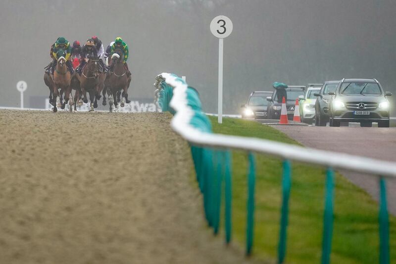 Support vehicles follow the runners during the Play 4 To Win At Betway Handicap at Lingfield Park Racecourse, in England, on Wednesday, January 27. Getty