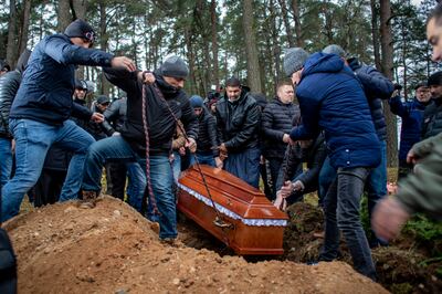 The coffin of Yemeni migrant Mustafa Mohammed Murshid al-Raymi is lowered into a grave at his funeral in Poland. EPA
