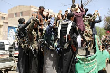 Armed Houthi followers ride on the back of a truck outside a hospital in Sanaa, Yemen. Reuters
