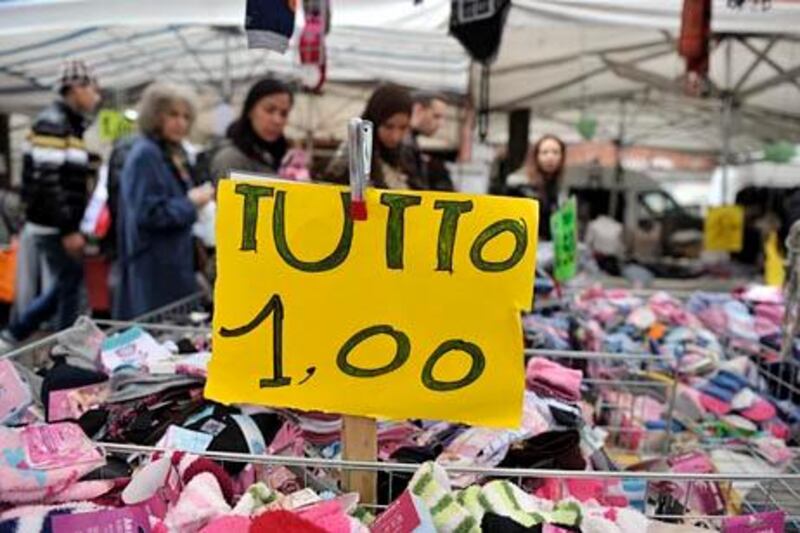 Customers shop at a local market in Milan November 8, 2011. Italy has the third biggest economy in the euro zone and its debt worries are a huge threat in the wider crisis facing the continent's single currency. REUTERS/Paolo Bona (ITALY - Tags: BUSINESS SOCIETY) - RTR2TQXI