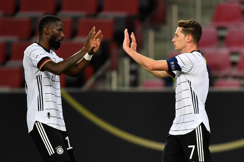 Germany's Julian Draxler, right, celebrates with Antonio Rudiger during 3-3 draw with Turkey in Cologne. AP
