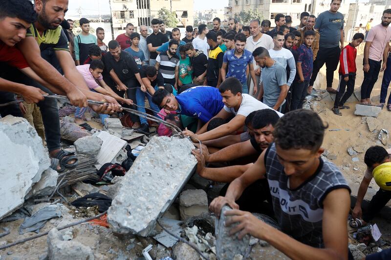 Palestinians search for casualties under the rubble of a house destroyed in Israeli strikes in Khan Younis, southern Gaza. Reuters