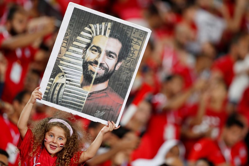 A young Egypt fan holds up a picture of Egypt's Mohamed Salah before the 2019 Africa Cup of Nations match against Uganda at the Cairo International Stadium in Cairo. Salah had been criticised in his homeland for defending teammate Amr Warda's expulsion from the squad over allegations of sexual harassment. Reuters