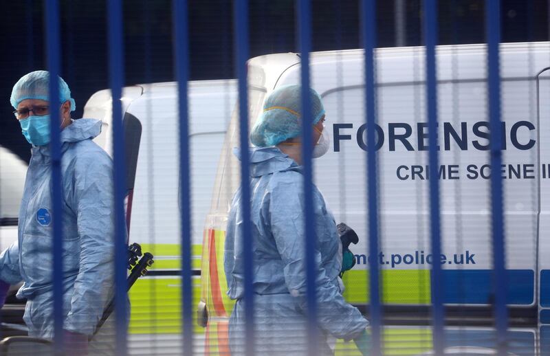 Forensic specialists are seen at the custody centre where a British police officer has been shot dead in Croydon, south London, Britain, September 25, 2020. REUTERS/Hannah McKay