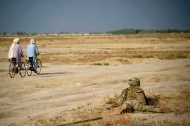 A US army soldier secures a street outside the district centre near Forward Operating Base Kuschamond in Kuschamond, Paktika province in 2011. AFP