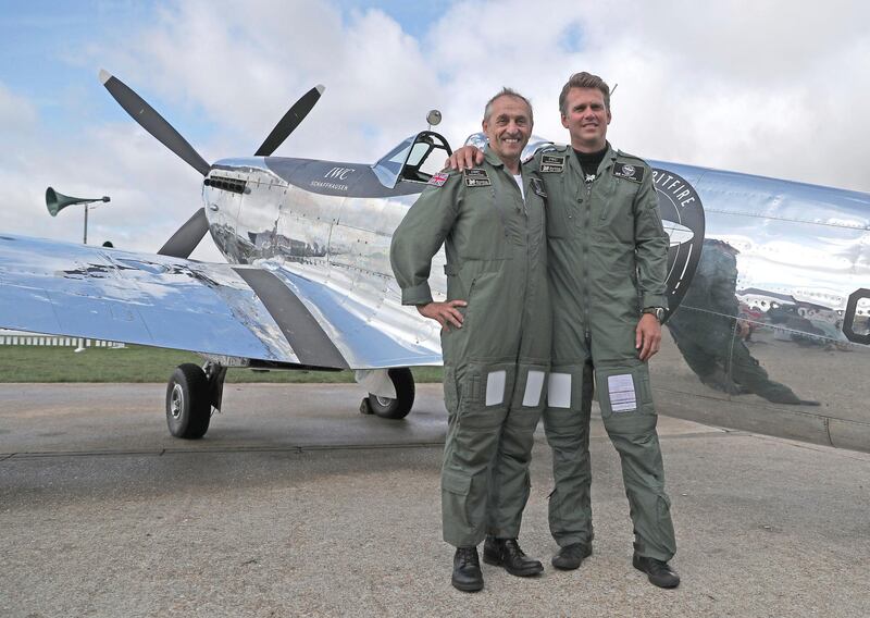 IWC Silver Spitfire pilots Matt Jones, right, and Steve Boultbee Brooks with their newly restored MK IX Spitfire at Goodwood Aerodrome in Goodwood, England. Steve Parsons / PA
