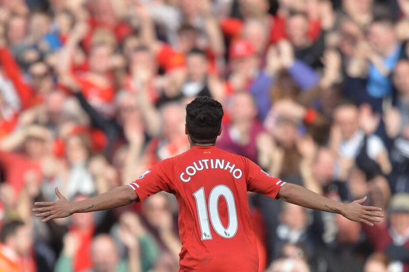 Liverpool FC midfielder Philippe Coutinho celebrates scoring his team's third goal against Tottenham Hotspur on Sunday. Paul Ellis / AFP / March 30, 2014