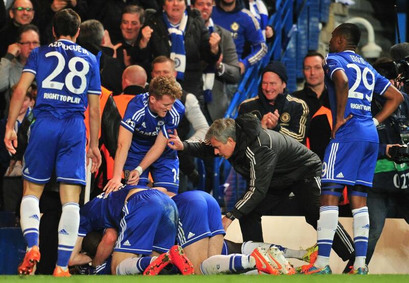 Chelsea's Portuguese manager Jose Mourinho talks to his players as they celebrate their second goal scored by Demba Ba at Stamford Bridge on Tuesday. Glyn Kirk / AFP / April 8, 2014