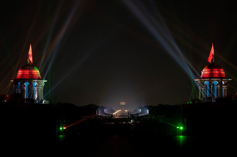 Government buildings on either side of the Rajpath are illuminated in the colours of the Indian flag. AP