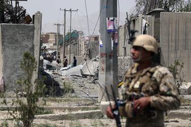 An Afghan security personnel stands guard at the site where a Taliban car bomb detonated at the entrance of a police station in Kabul. Scores of people were wounded. AFP