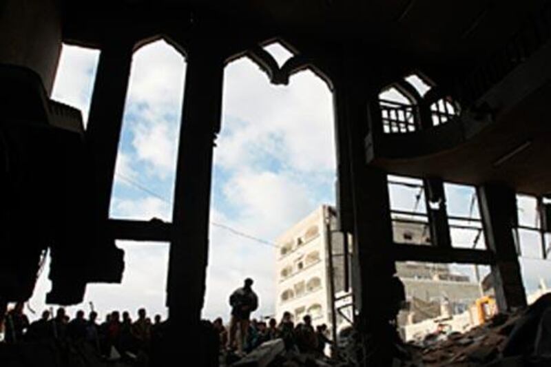 Palestinians look at the destroyed al Kolafa mosque after an Israeli air strike.