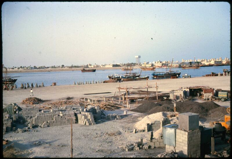 Construction about to start on Dubai Creek, with a water tower and traditional buildings visible