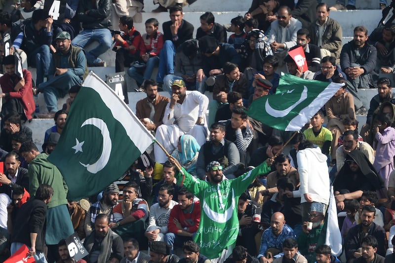 Spectator wave Pakistani flags during the third day of the first Test in Rawalpindi. AFP