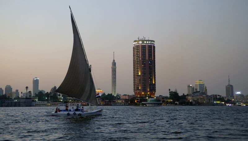 epa08615377 A sailboat on the Nile river with the Cairo Tower (C) and Sofitel Cairo Nile El Gezirah hotel in the background, in Cairo, Egypt, 20 August 2020.  EPA/KHALED ELFIQI