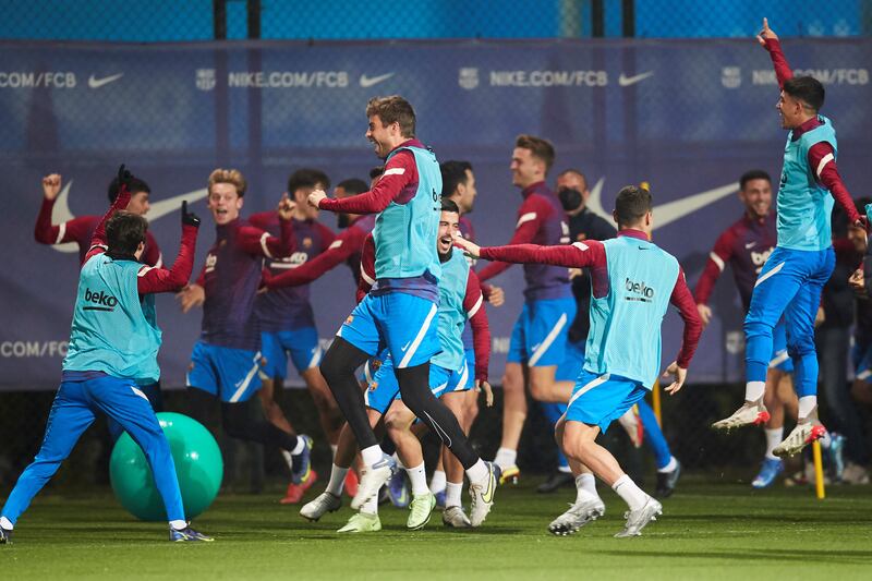 Barcelona players share a light moment during a team training session at Joan Gamper sport complex in Barcelona. EPA