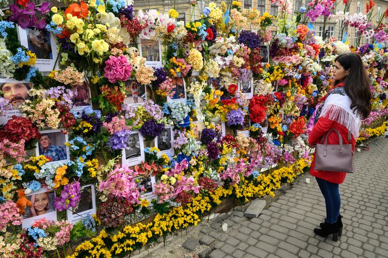 A floral memorial wall in Lviv for Ukrainian civilians killed during the Russian invasion, April 2022. Getty Images