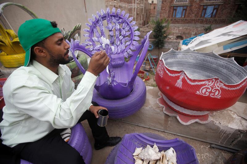 A worker decorates a piece of furniture at Sufian Noaman's tire recycling workshop in Sanaa, Yemen.  Reuters