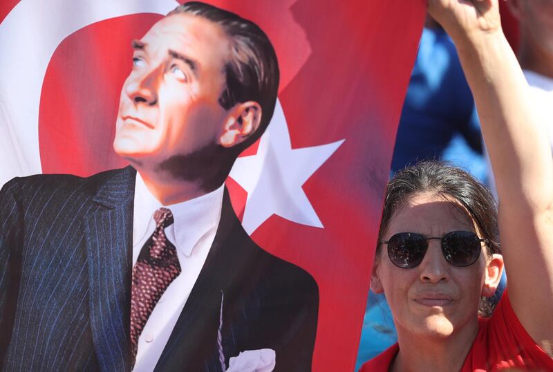 A supporter of Mr Imamoglu holds a Turkish flag. EPA