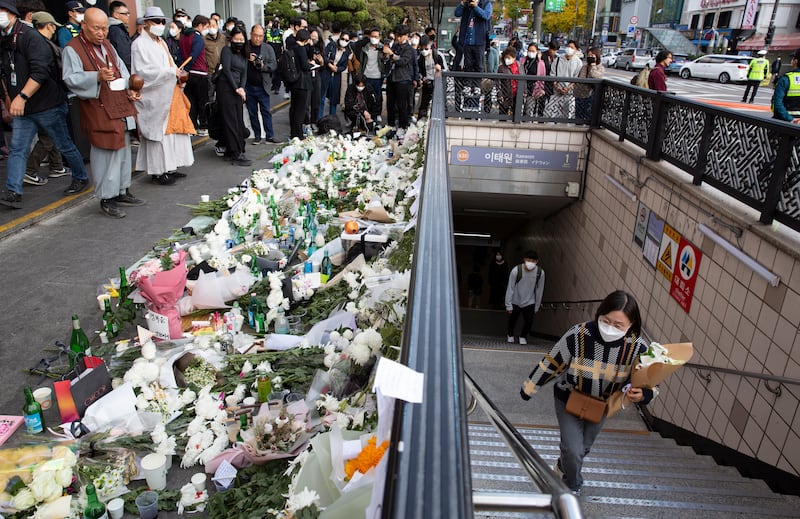 People arrive to pay tribute to victims of the Seoul Halloween stampede. EPA