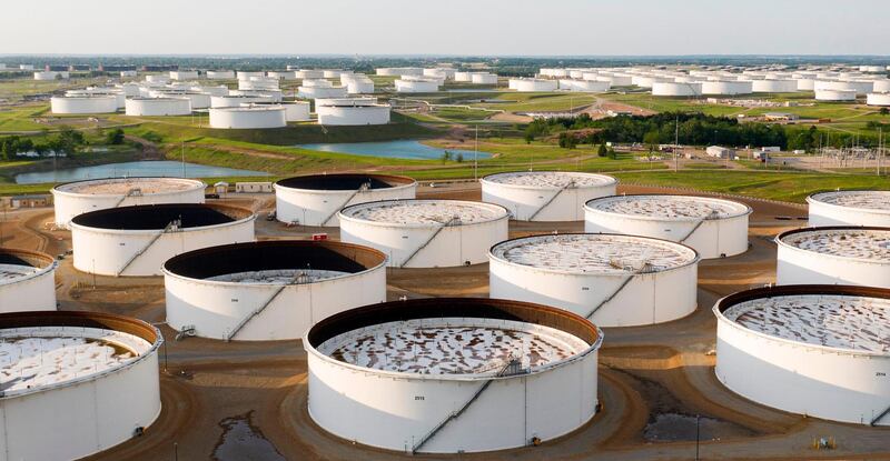 An aerial view of a crude oil storage facility is seen on May 4, 2020 in Cushing, Oklahoma. Using his fleet of drones, Dale Parrish tracks one of the most sensitive data points in the oil world: the amount of crude stored in giant steel tanks in Cushing, Oklahoma. The West Texas Intermediate oil stored in the small town in the midwestern United States is used as a reference price for crude bought and sold by refiners in Asia, hedge funds in London and traders in New York. / AFP / Johannes EISELE / TO GO WITH AFP STORY by Juliette MICHEL: "Cushing, Oklahoma: the town global oil markets depend on"
