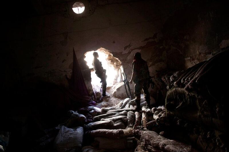 Time for a rest as Free Syrian Army fighters take a break in a storage room in the Karmal Jabl district of Aleppo before more fighting.