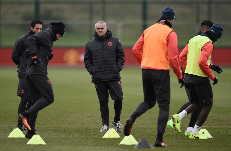 Manchester United's Portuguese manager Jose Mourinho (C) takes a training session at their Carrington base in Manchester, northwest England, on February 15, 2017, on the eve of their UEFA Europa League Round of 32 first-leg football match against Saint-Etienne on February 16. / AFP PHOTO / Oli SCARFF
