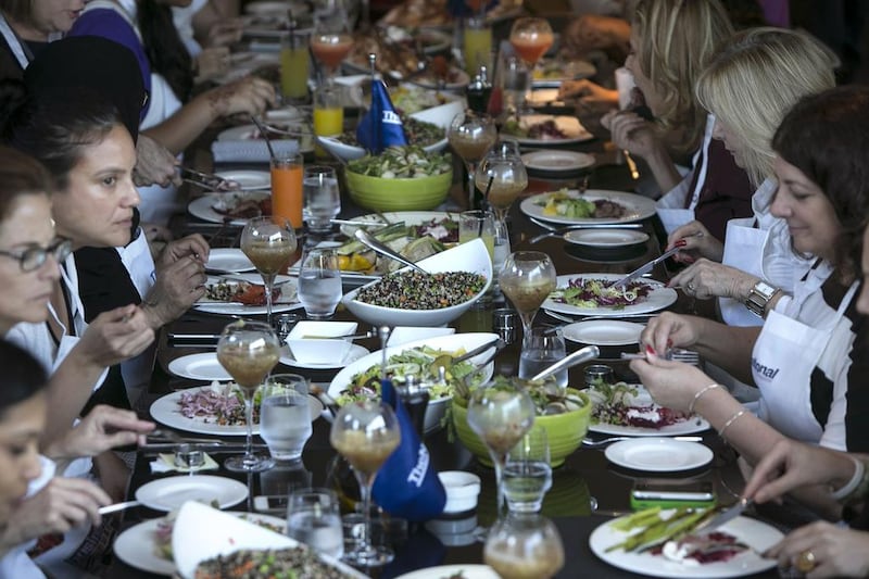 Guests and The National staff enjoy the food and the company after a morning spent cooking at the #healthyliving cooking experience. Silvia Razgova / The National