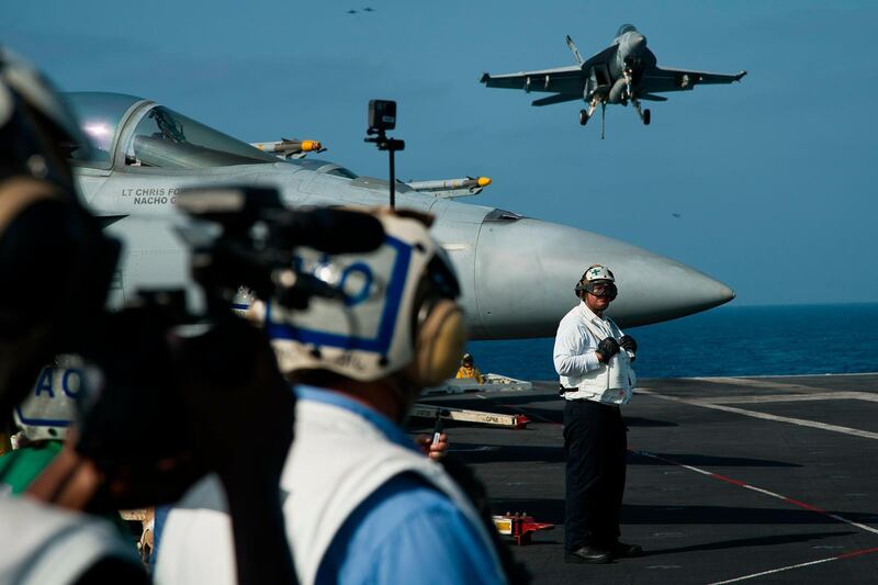 An F/A-18 fighter jet lands on the deck of the USS Abraham Lincoln aircraft carrier. AP