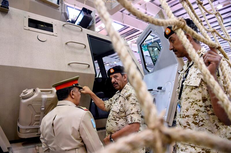 Bahrain Defence Force's (BDF) Commander-in-Chief Field Marshal Sheikh Khalifa bin Ahmed Al-Khalifa (C) inspects an armored vehicle at the Bahrain International Defence Exhibition & Conference (BIDEC) 2019 in the Bahraini capital Manama on October 29, 2019. The two-day Middle East Military Technology Conference (MEMTEC) focusing on the future of military technology, cyber defence strategies, and the impact of artificial intelligence opened on the sidelines of three-day Bahrain International Defence Exhibition & Conference (BIDEC) 2019 which opened a day earlier. BIDEC, which will run until 30 October 2019, has exhibitors from over 30 countries including the US, UK, Italy, Spain, Russia, Jordan, Saudi Arabia, United Arab Emirates (UAE) among others.  / AFP / Mazen Mahdi
