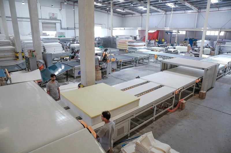 A mattress gets moved on a hightech conveyor belt to the next stage of production. Workers used to have to carry each mattress to the next area in the “old days” of production. Victor Besa for The National