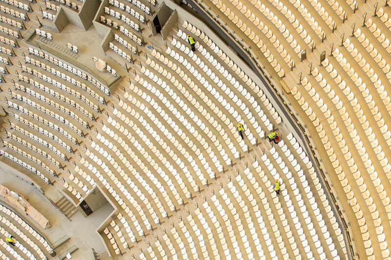 Construction workers clean the seats inside the Lusail Stadium. The stadium will host 10 games including the final of the 2022 World Cup. Getty