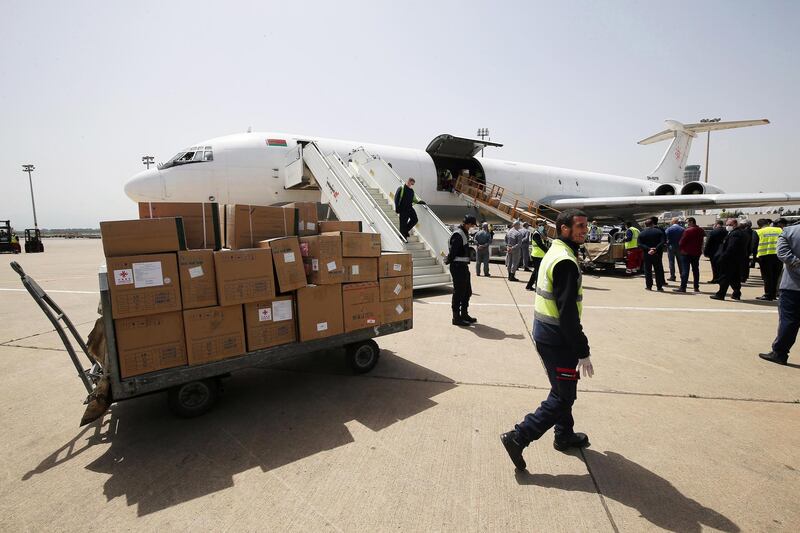 Workers unload medical supplies from China at Houari Boumediene International Airport in Algiers, Algeria.  EPA
