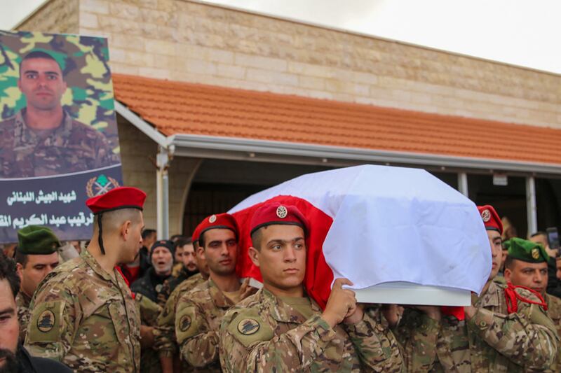 Comrades carry the coffin of a Lebanese soldier who was killed by Israeli fire on a border post in southern Lebanon on December 5. AFP