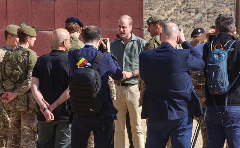 Prince William (C), Duke of Cambridge, speaks with soldiers while attending the Exercise Desert Warrior between British and Kuwaiti forces at Sheikh Salem al-Ali al-Sabah Camp, about 40 kilometres north of Kuwait City.  AFP