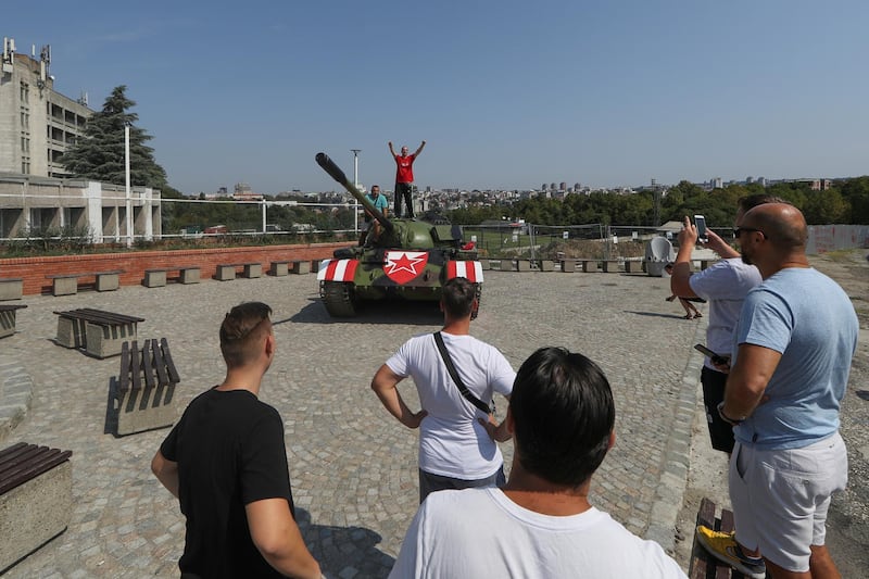 A Red Star Belgrade fan stands on the Soviet-made T-55 main battle tank in front of Rajko Mitic stadium. Reuters