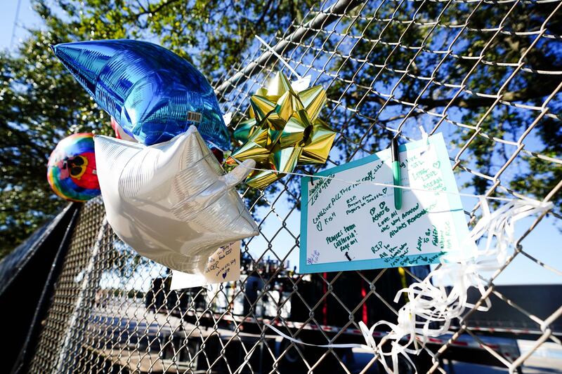 Letters and balloons commemorating people who died in the crush are attached to the fence that surrounds NRG Park. AFP