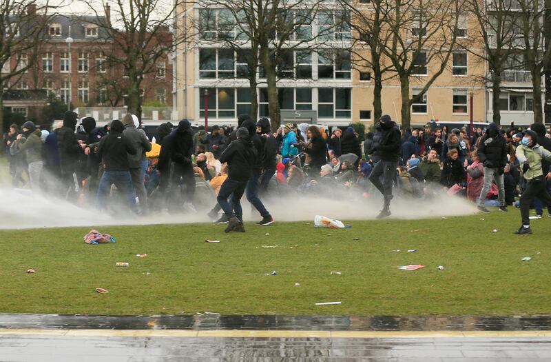 Police uses a water canon during a protest against restrictions put in place to curb the spread of the coronavirus disease (COVID-19), in Amsterdam, Netherlands January 24, 2021. REUTERS/Eva Plevier