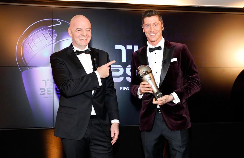 Bayern Munich's Robert Lewandowski receives the the men's player of the year trophy from Gianni Infantino during Fifa The BEST Awards ceremony in Munich. Getty