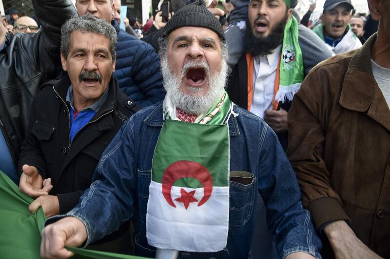Algerian protesters chant as they take part in an anti-government demonstration in the capital Algiers, on January 31, 2020. Anti-government protesters were back on the street in large numbers for the 50th consecutive week, ahead of the 1 year anniversary of the "Hirak", a months-long unprecedented reform movement calling for ending a system in place since the country's independence from France in 1962. / AFP / RYAD KRAMDI                        

