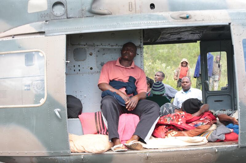 Injured people rest in a helicopter in Chimanimani. EPA
