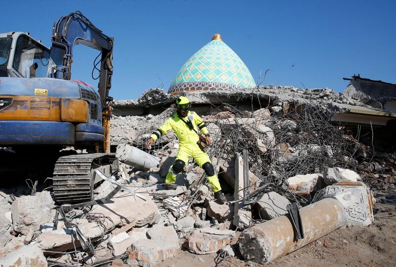 A rescuer climbs over debris of a collapsed mosque after an earthquake struck northern Lombok, West Nusa Tenggara, Indonesia.  EPA