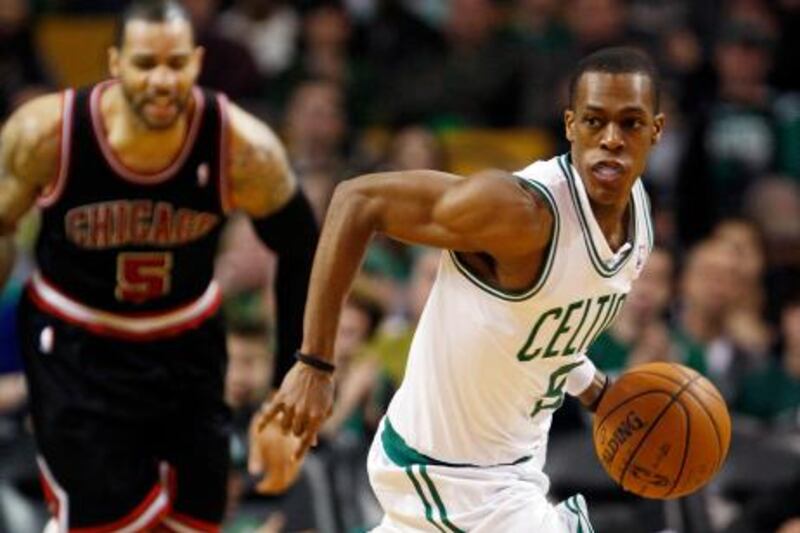 Boston Celtics Rajon Rondo (R) drives past Chicago Bulls Carlos Boozer in the second half of their NBA basketball game at TD Garden in Boston, Massachusetts February 12, 2012. REUTERS/Jessica Rinaldi (UNITED STATES - Tags: SPORT BASKETBALL) *** Local Caption ***  BOS107_NBA-_0212_11.JPG