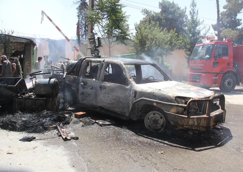 A burning military vehicle is seen in front of government compound, during a protest in Maimana, capital of Faryab province, Afghanistan on July 4, 2018. Reuters